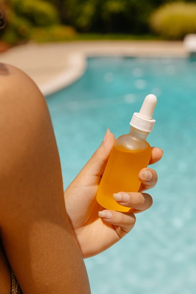 Woman Holding a Bottle of Serum